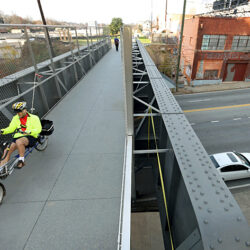 December 6, 2012 - Atlanta, Ga: A person bicycles on the eastside bridge of the Beltline crossing over Ponce De Leon Avenue near Paris on Ponce, top right, Thursday afternoon in Atlanta, Ga., December 6, 2012. Crews said she enjoys the Beltline trail but wishes there were more trees and garbage cans.  Some government agencies are struggling to overcome lagging trust, but Atlanta Mayor Kasim Reed cautions against overblowing the issue.  Though the T-SPLOST failed in every county, it gained a majority of votes in the city of Atlanta. The measure would have funded the Beltline rail system, which the city now plans to build with other funds. This is a recently opened trail that would accompany the future rail line. JASON GETZ / JGETZ@AJC.COM